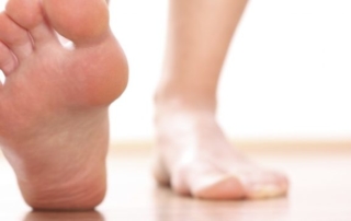 closeup of bare feet in need of running shoes for workout