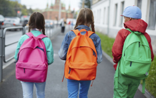 children wearing a backpack in a way to keep their back in good shape