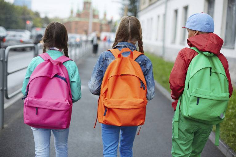 children wearing a backpack in a way to keep their back in good shape