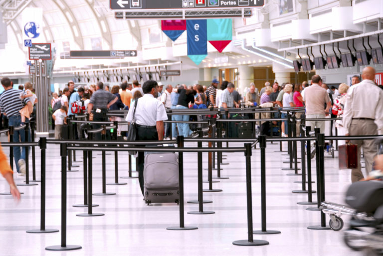 Passengers lining up at check-in counter at the modern international airport