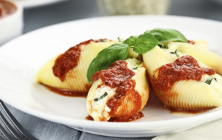 Conchigliei pasta stuffed with a ricotta cheese, mozerella and basil leaves with extreme shallow depth of field