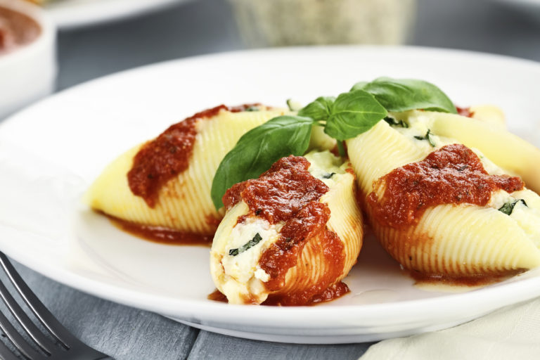 Conchigliei pasta stuffed with a ricotta cheese, mozerella and basil leaves with extreme shallow depth of field