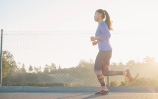 side view of woman running on running track
