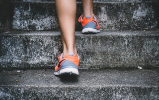 closeup of the back of a woman's feet while walking up stairs