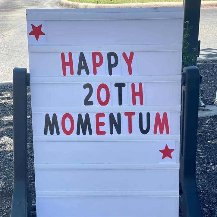 sign to celebrate Momentum Physical Therapy's 20th anniversary