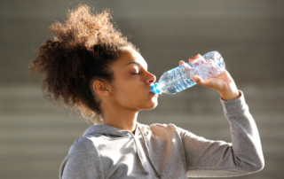Woman drinking water to stay hydrated